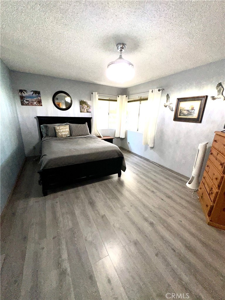 6612 Southampton Drive Cypress, CA 90630 - Photo 18 of 27 a bedroom with a bed and wooden floor