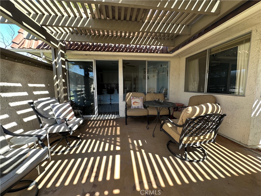 6612 Southampton Drive Cypress, CA 90630 - Photo 21 of 27 a view of a patio with couches table and chairs with wooden floor