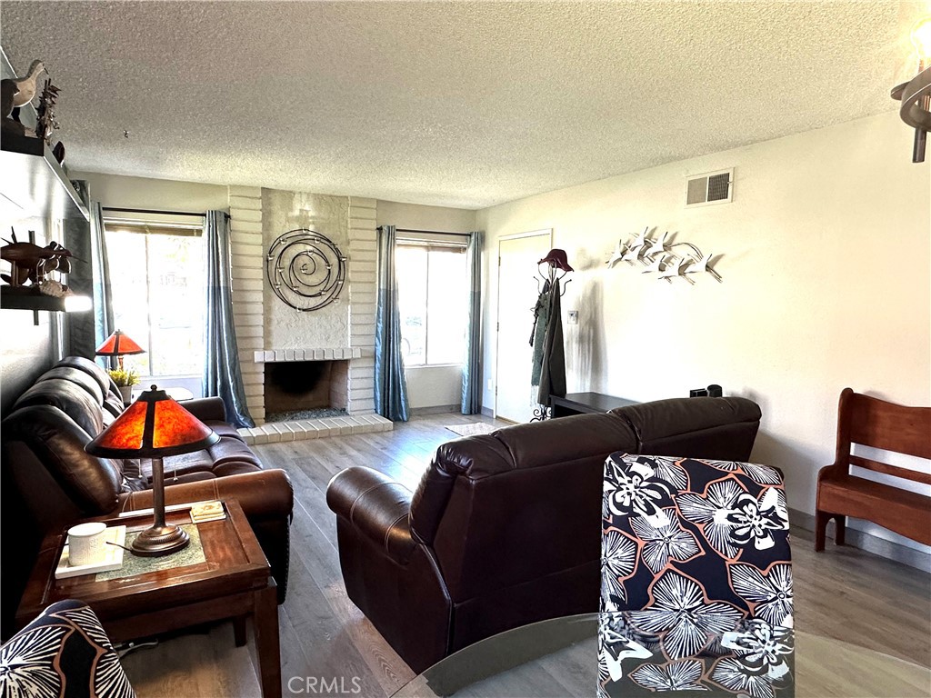 6612 Southampton Drive Cypress, CA 90630 - Photo 3 of 27 a living room with furniture a fireplace and a flat screen tv