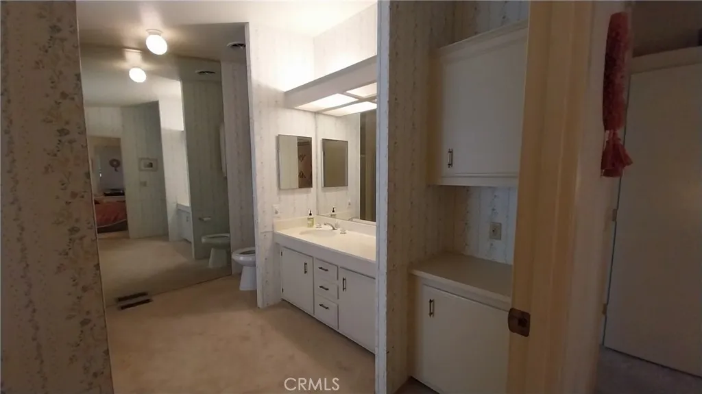 205 Thunderbird Lane, Unit 2 Needles, CA 92363 - Photo 14 of 71 a bathroom with a tub sink vanity and mirror