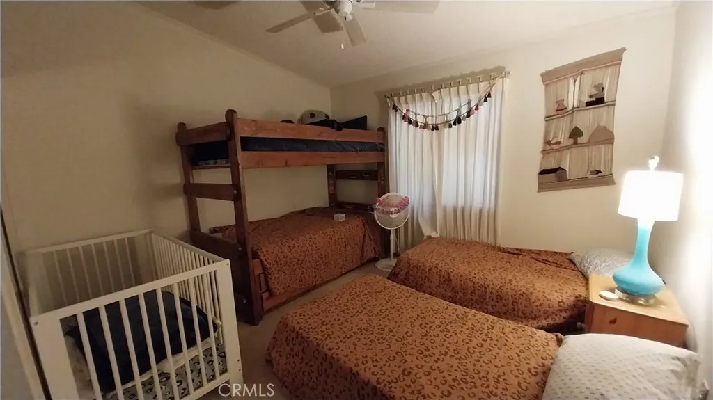 205 Thunderbird Lane, Unit 2 Needles, CA 92363 - Photo 20 of 71 a bedroom with two beds and a dresser with wooden floor