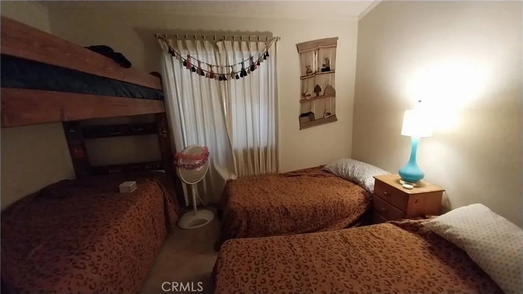 205 Thunderbird Lane, Unit 2 Needles, CA 92363 - Photo 21 of 71 a bedroom with two beds and a dresser