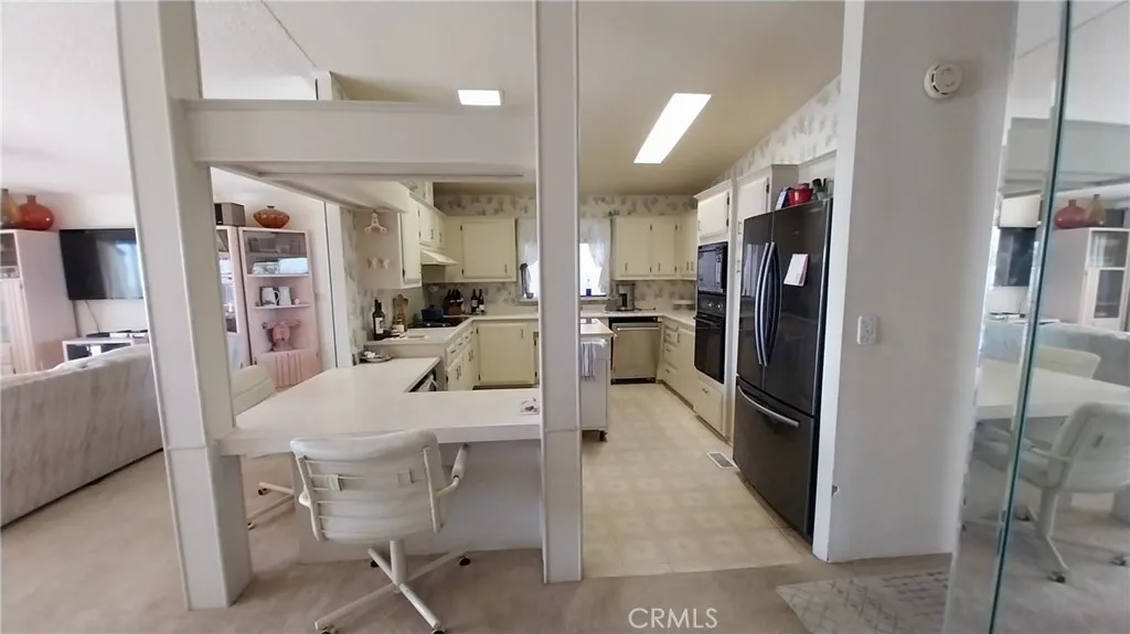 205 Thunderbird Lane, Unit 2 Needles, CA 92363 - Photo 28 of 71 a large kitchen with a table and chairs