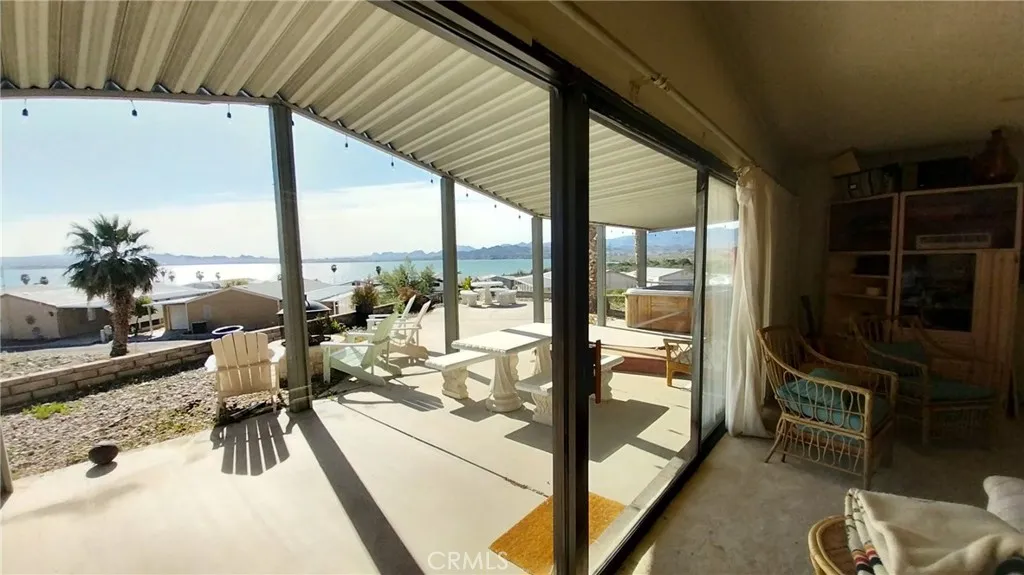 205 Thunderbird Lane, Unit 2 Needles, CA 92363 - Photo 33 of 71 a very nice looking room with a large window and flat screen tv