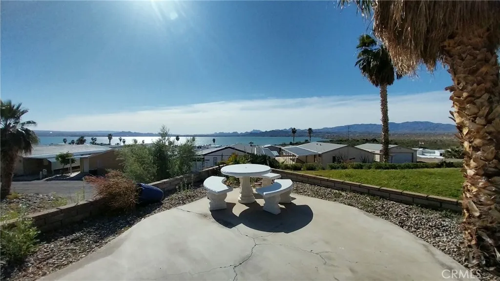 205 Thunderbird Lane, Unit 2 Needles, CA 92363 - Photo 40 of 71 a view of a backyard with table and chairs plants and mountain view