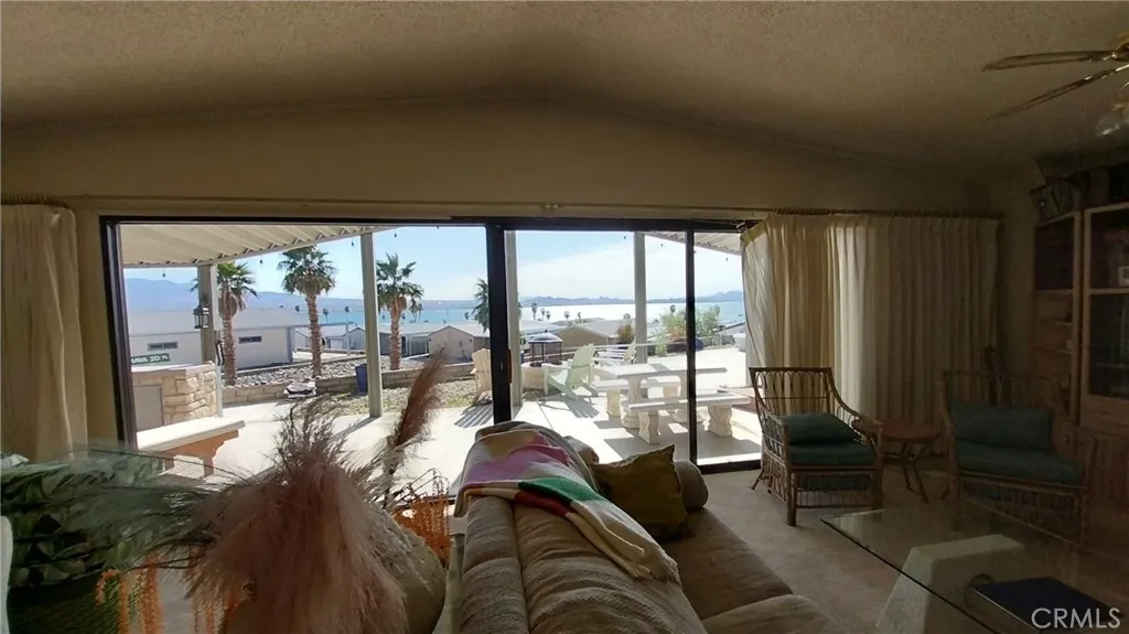 205 Thunderbird Lane, Unit 2 Needles, CA 92363 - Photo 50 of 71 a living room with furniture and floor to ceiling window