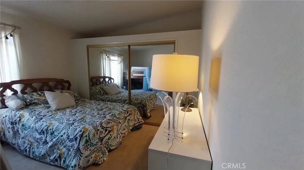 205 Thunderbird Lane, Unit 2 Needles, CA 92363 - Photo 7 of 71 a bedroom with a bed and wooden floor