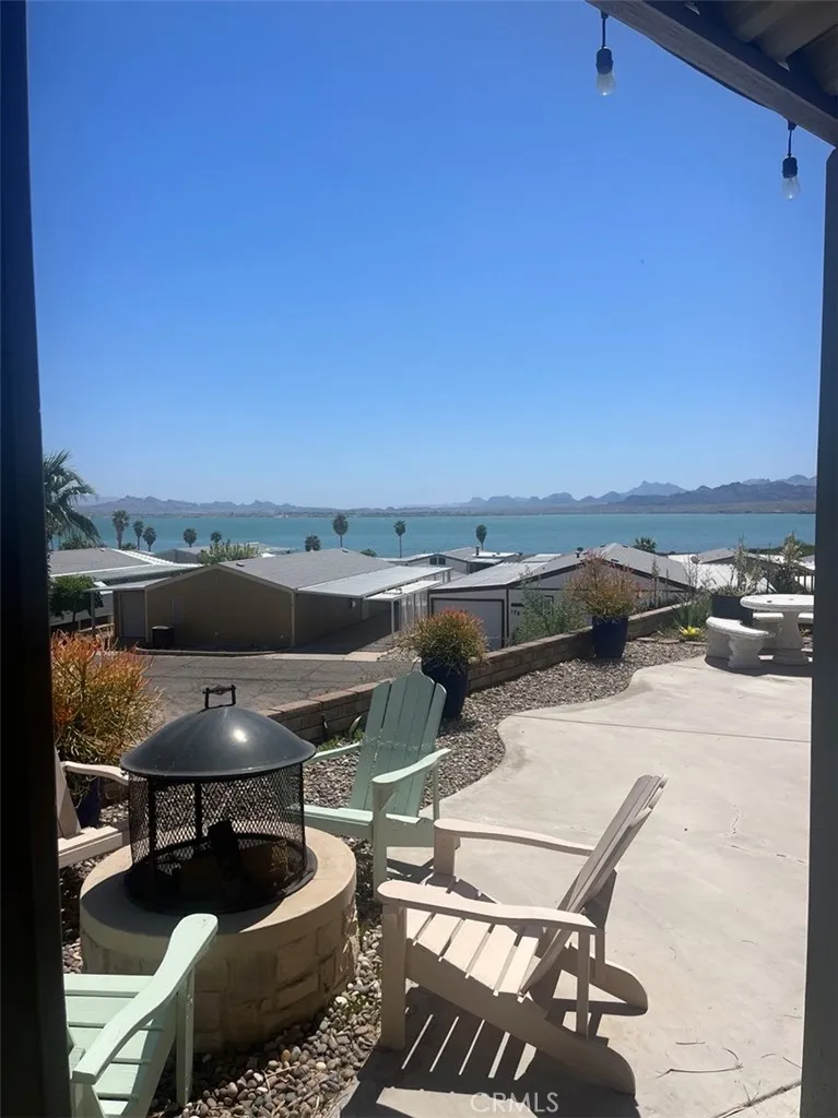 205 Thunderbird Lane, Unit 2 Needles, CA 92363 - Photo 71 of 71 a terrace with a table and chairs and a barbeque