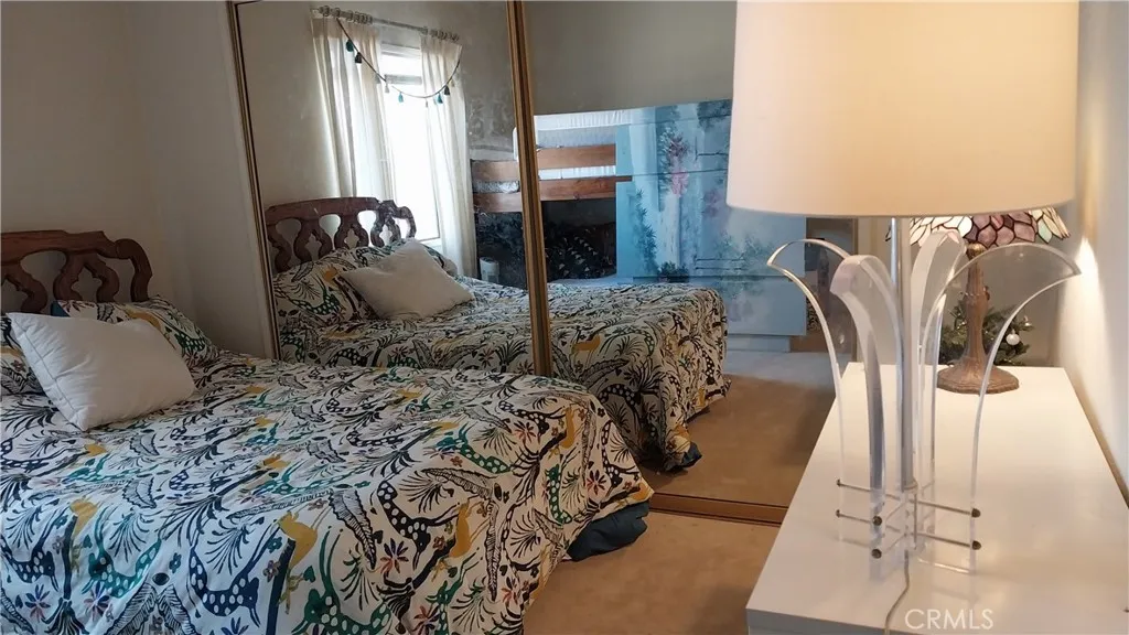 205 Thunderbird Lane, Unit 2 Needles, CA 92363 - Photo 8 of 71 a bedroom with bed and wooden floor