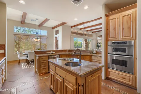 a kitchen with a stove a sink and a refrigerator