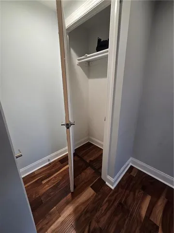 a room with wooden floor and a window