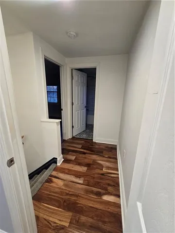 a view of a room with wooden floor and staircase