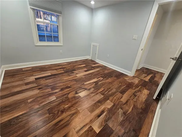 a view of a room with wooden floor and window
