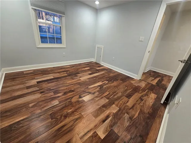 a view of a room with wooden floor and window