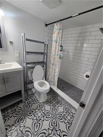 a bathroom with a toilet and a shower