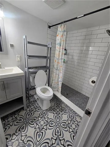 a bathroom with a toilet and a shower