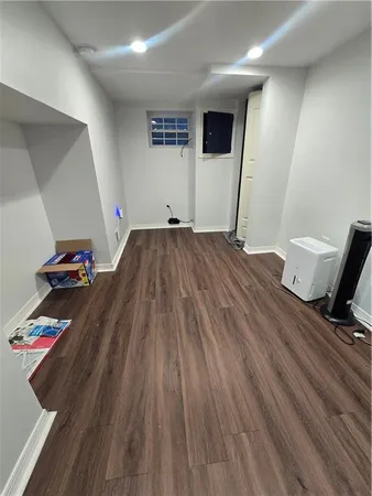 a view of a livingroom with wooden floor and furniture