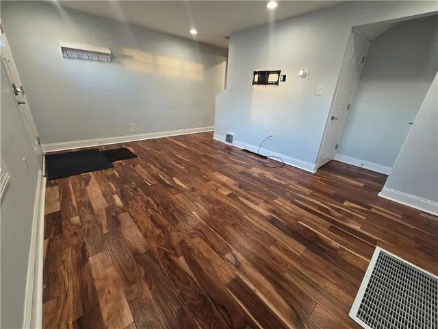 an empty room with wooden floor