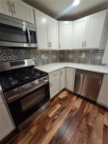 a kitchen with granite countertop a stove and a sink