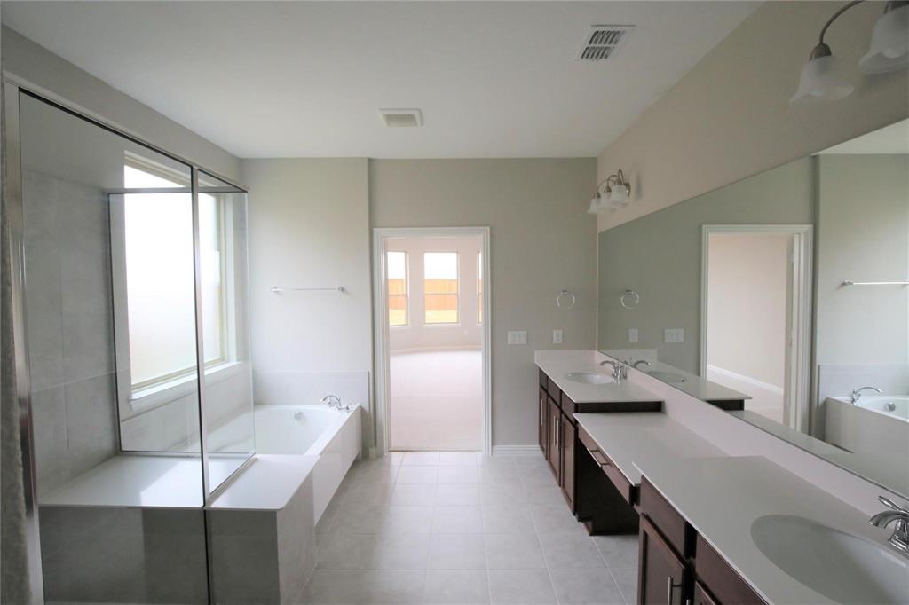 15142 Rosario Road Frisco, TX 75035 - Photo 14 of 21 Spacious bathroom featuring a dual vanity with white countertops, dark wood cabinetry, and an expansive wall-mounted mirror