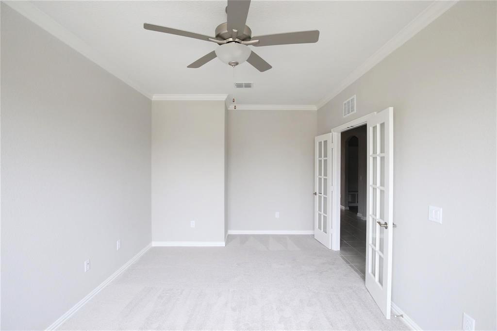 15142 Rosario Road Frisco, TX 75035 - Photo 15 of 21 Carpeted room featuring crown molding and a ceiling fan with light