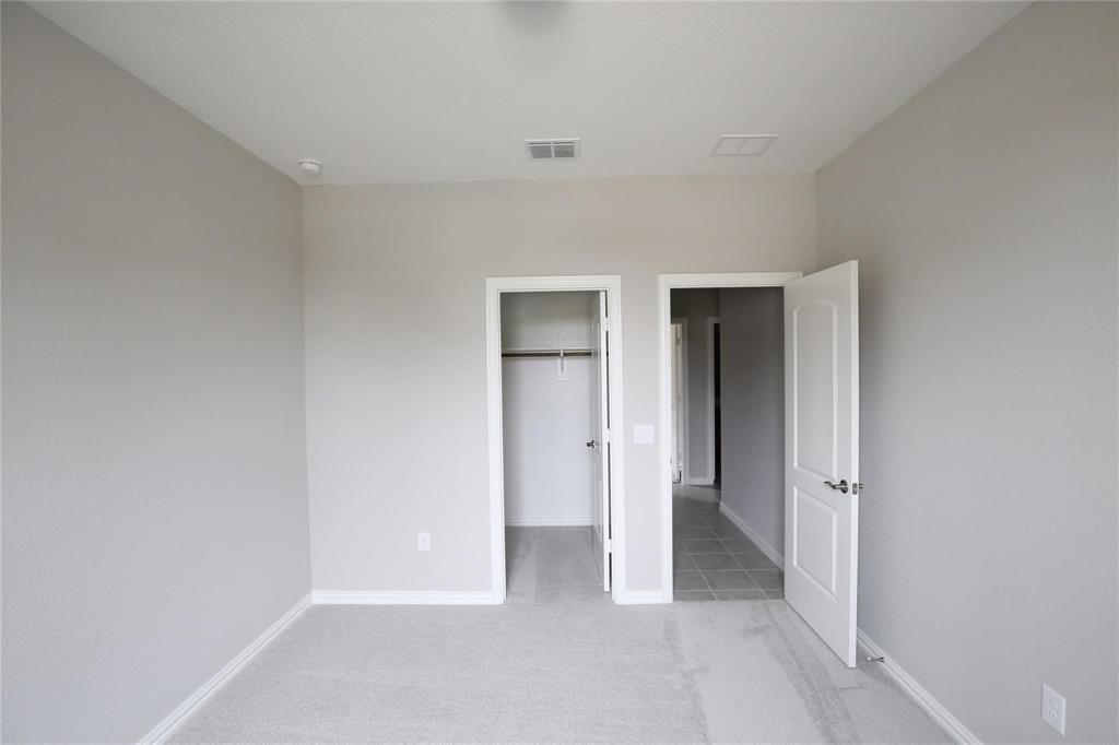 15142 Rosario Road Frisco, TX 75035 - Photo 19 of 21 Neutral-toned room featuring light gray walls, light gray carpet, and white baseboards