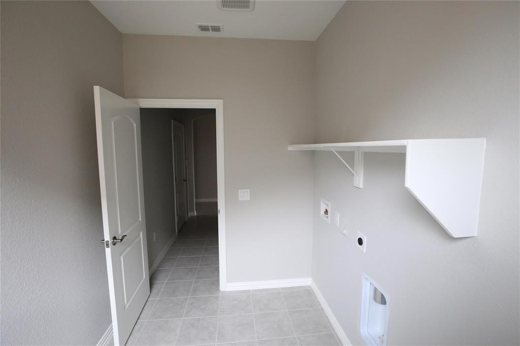 15142 Rosario Road Frisco, TX 75035 - Photo 21 of 21 Dedicated laundry area featuring a built-in white shelf for storage and organization