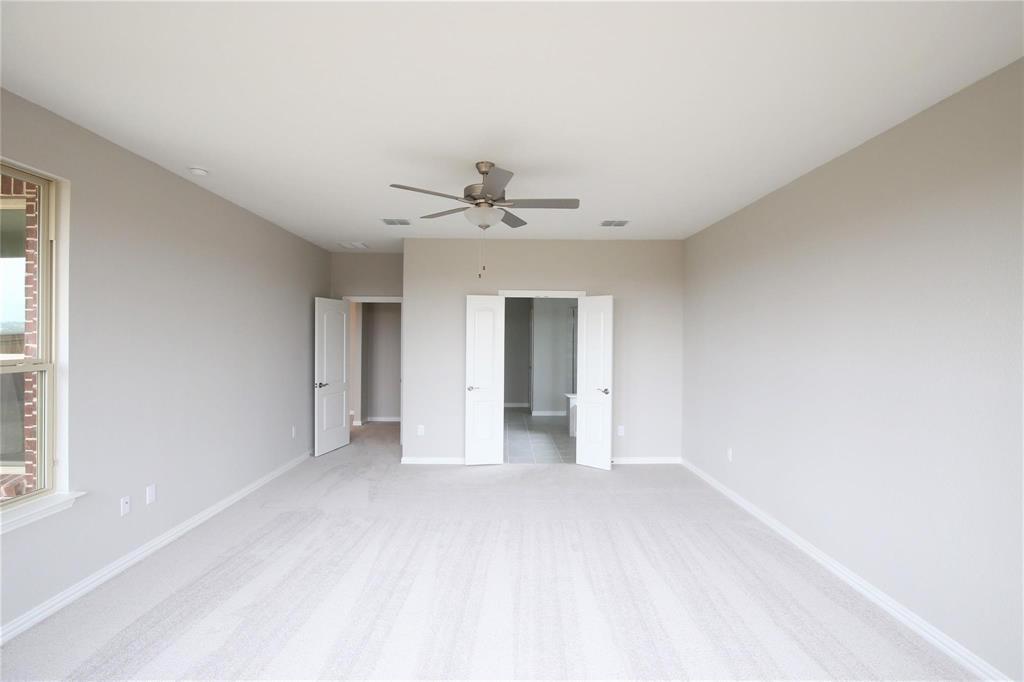 15142 Rosario Road Frisco, TX 75035 - Photo 9 of 21 Spacious room featuring light-colored carpet flooring, neutral painted walls, and a ceiling fan with integrated lighting