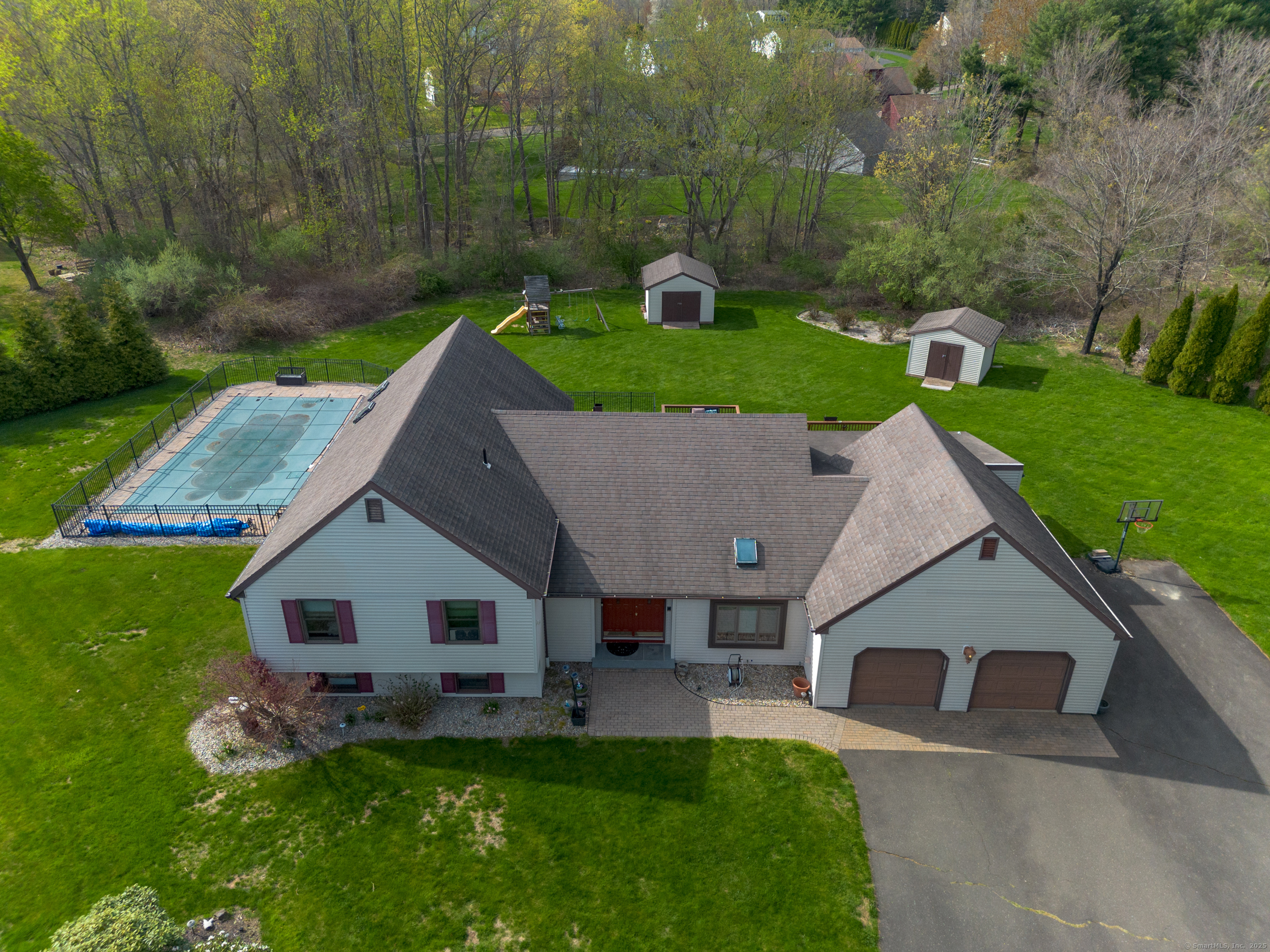 a aerial view of a house with a yard table and chairs
