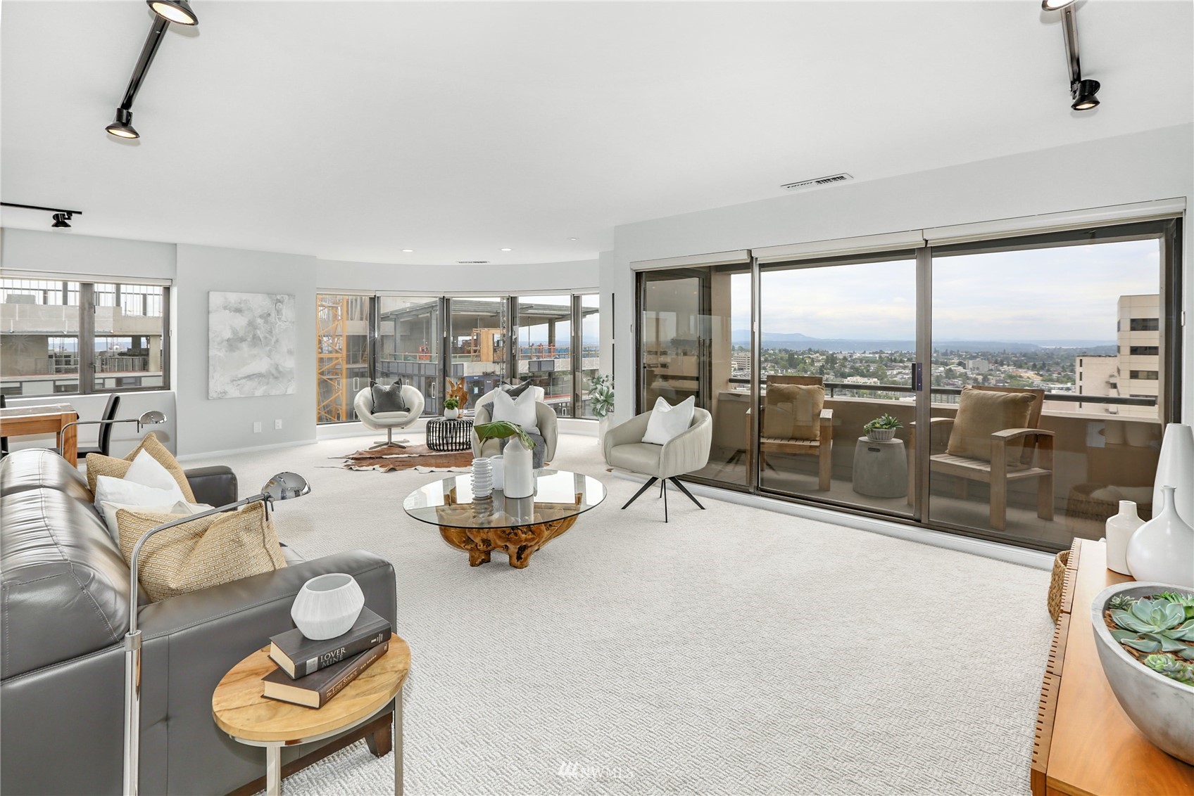 1301 Spring Street, Unit 18H Seattle, WA 98104 - Photo 11 of 38 a living room with furniture and a floor to ceiling window