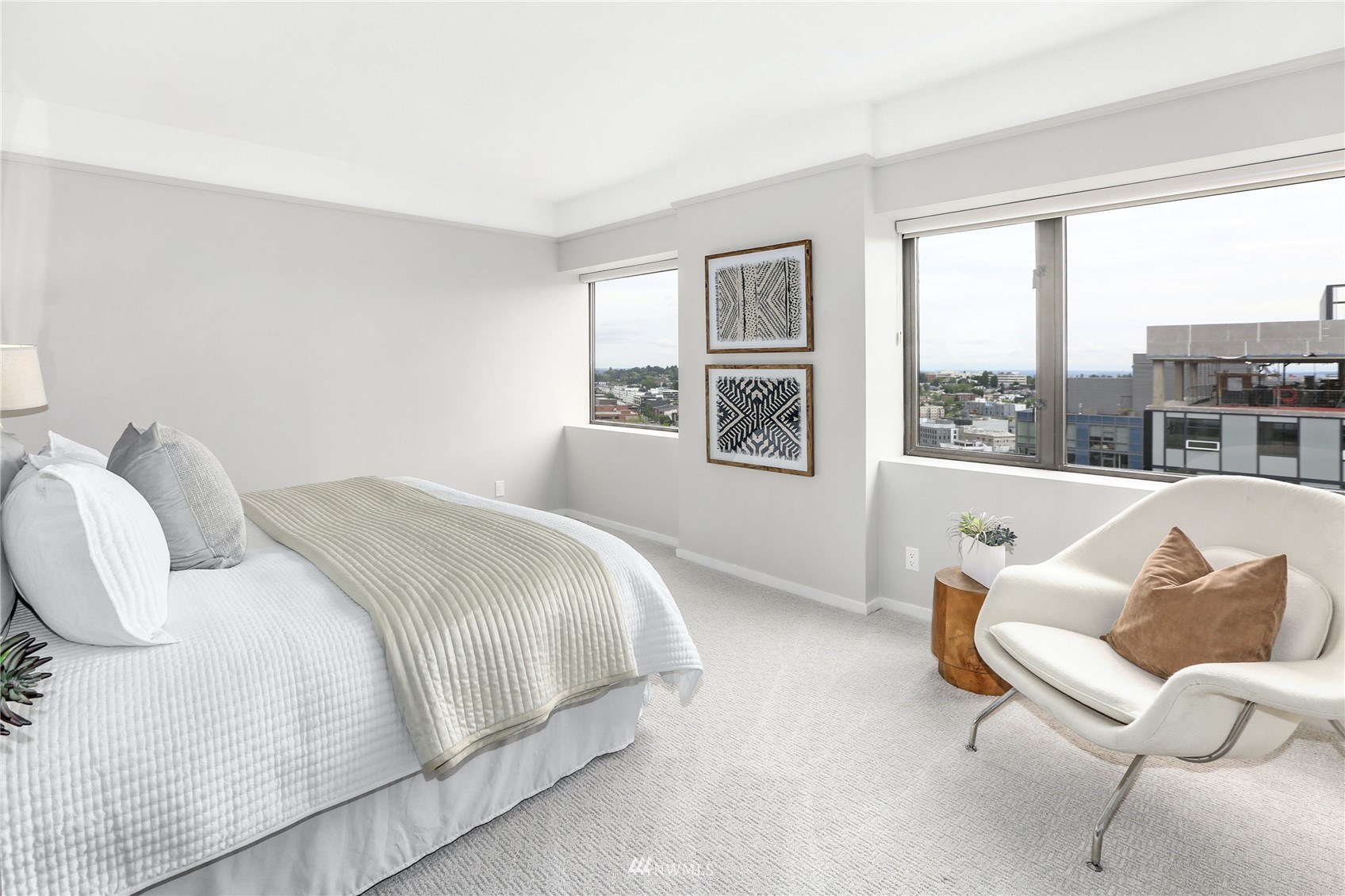 1301 Spring Street, Unit 18H Seattle, WA 98104 - Photo 20 of 38 a bedroom with a bed and wooden floor
