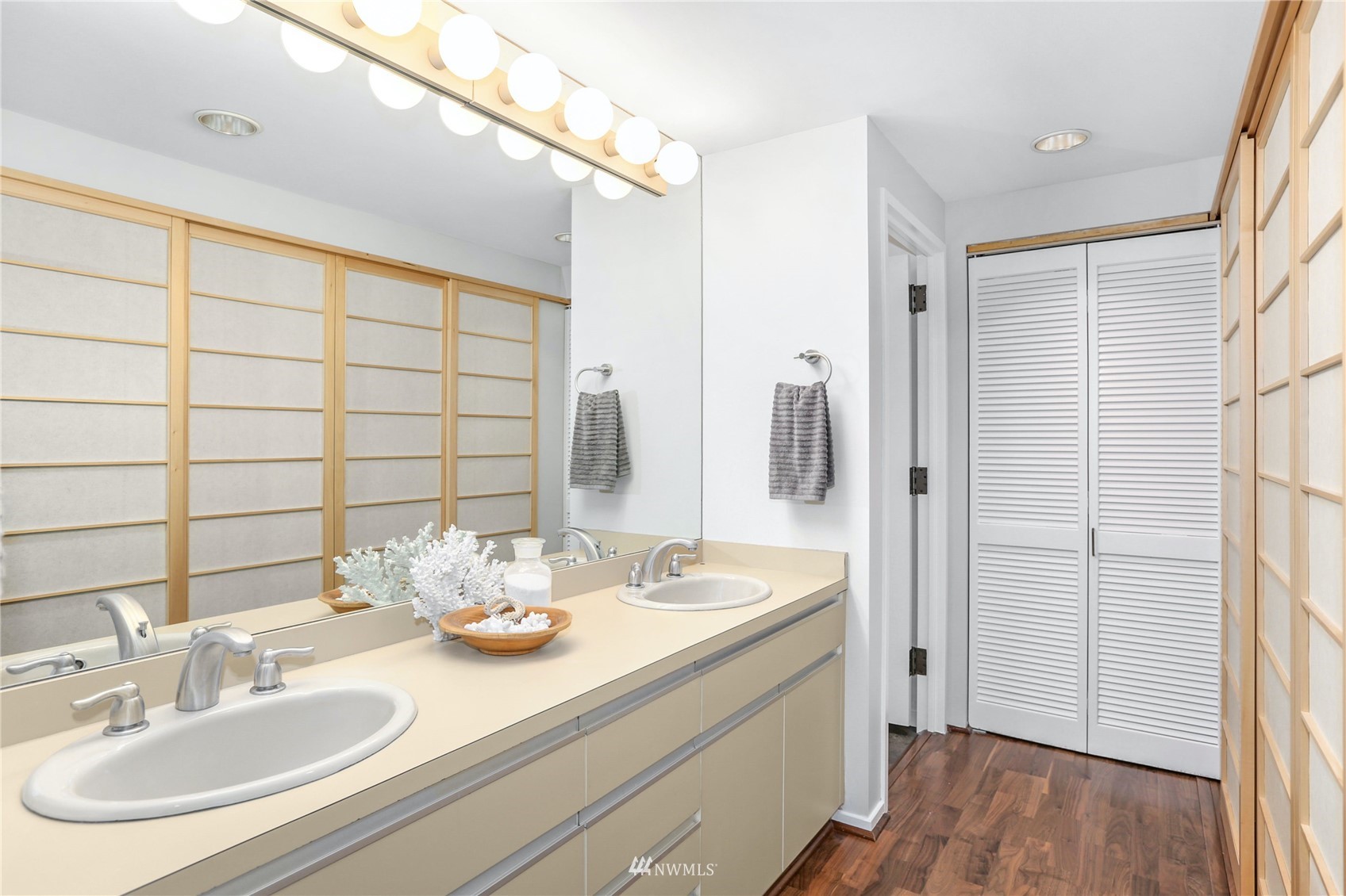 1301 Spring Street, Unit 18H Seattle, WA 98104 - Photo 21 of 38 a bathroom with a sink and a mirror