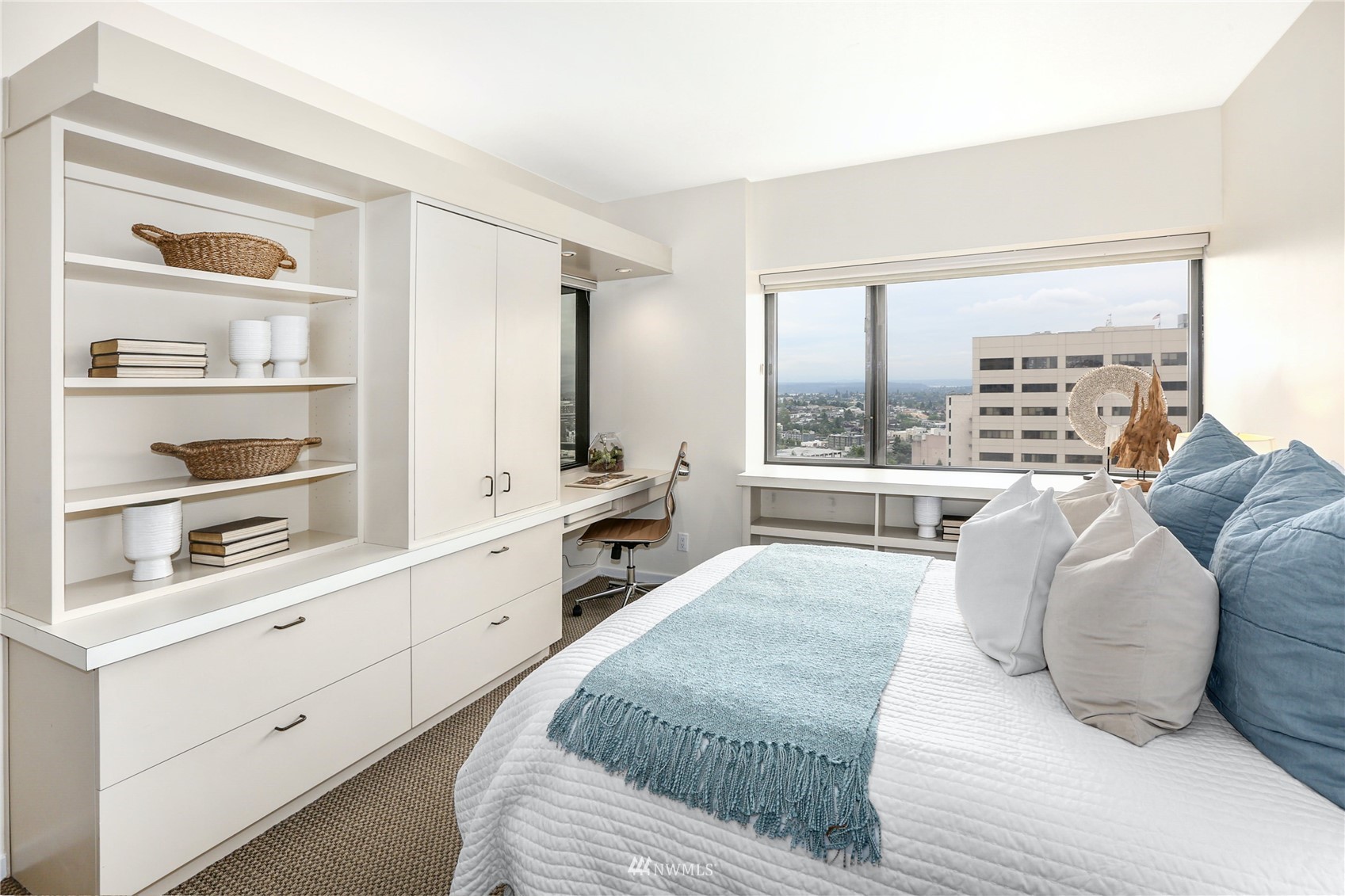 1301 Spring Street, Unit 18H Seattle, WA 98104 - Photo 26 of 38 a large bedroom with a large bed and a window