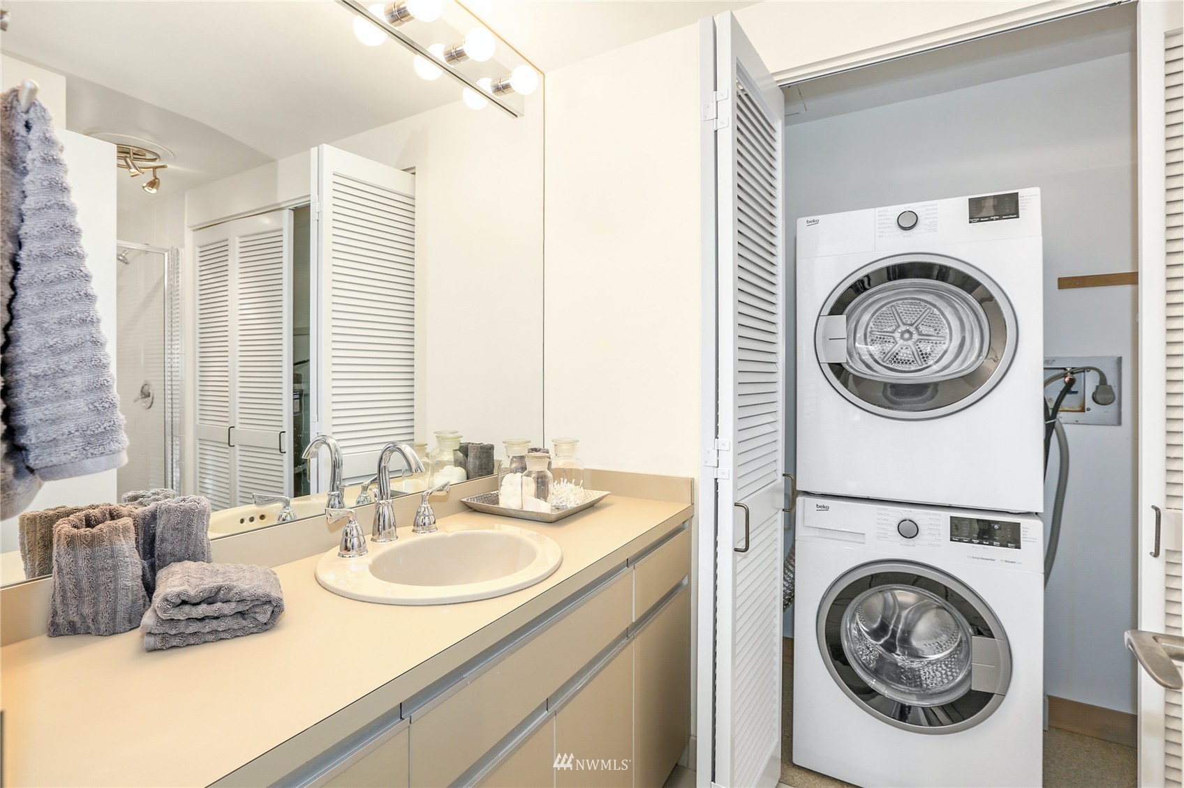 1301 Spring Street, Unit 18H Seattle, WA 98104 - Photo 28 of 38 a bathroom with a sink and a washing machine with a sink