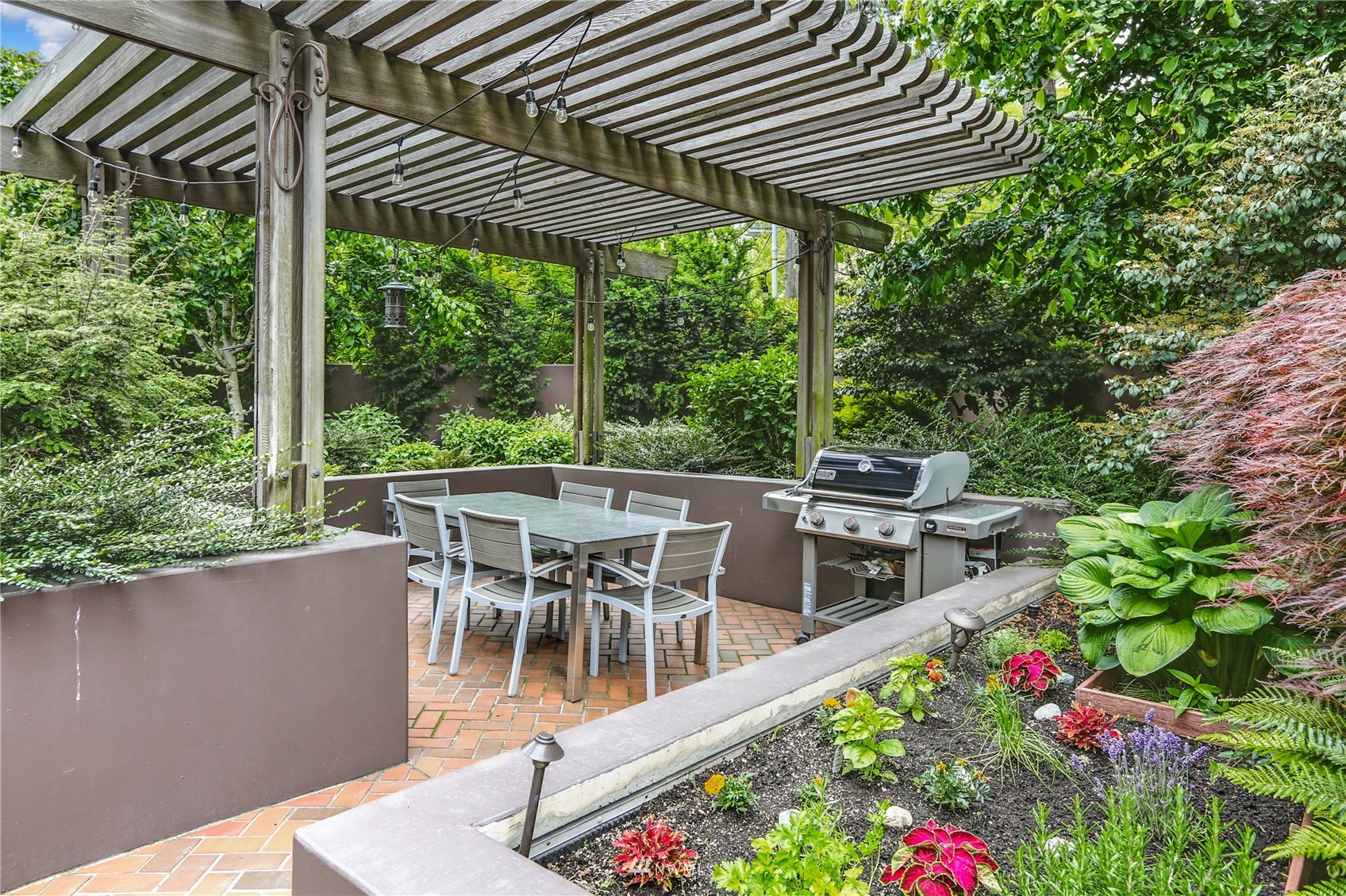 1301 Spring Street, Unit 18H Seattle, WA 98104 - Photo 4 of 38 a view of a patio with a table chairs and a table