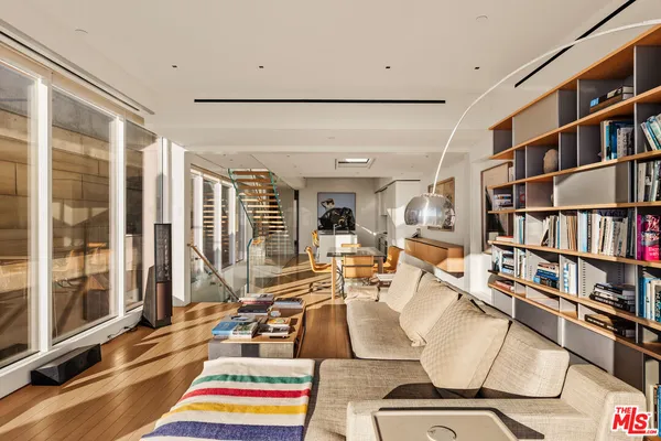 a living room with lots of furniture and chandelier