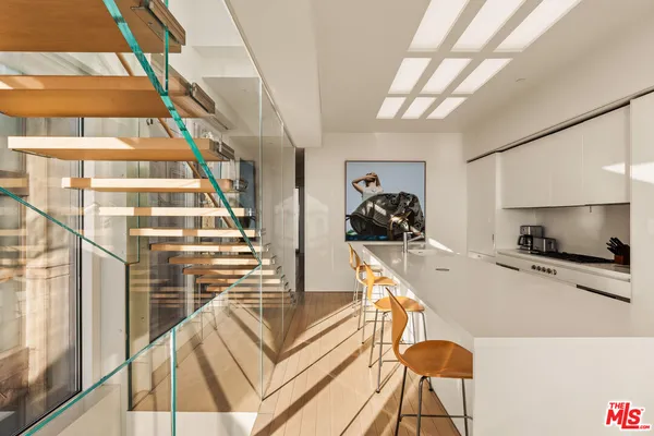 a kitchen with stainless steel appliances granite countertop a sink and a stove