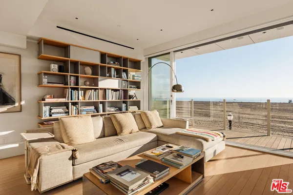 a living room with furniture and a floor to ceiling window