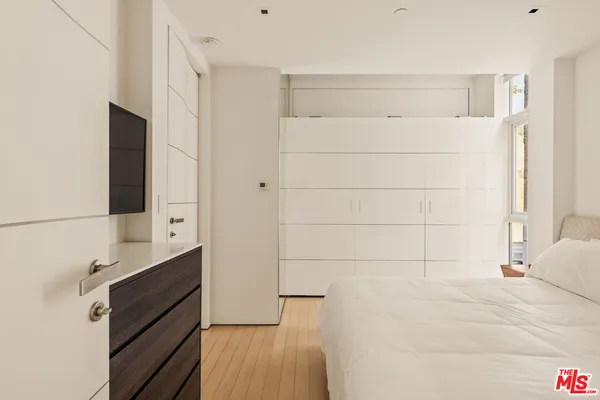 a view of a room with wooden floor and windows