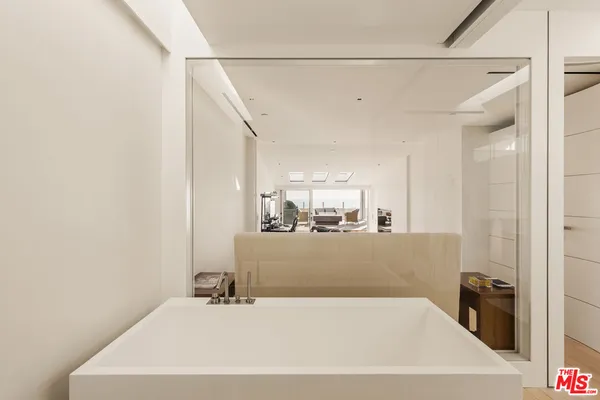 a bathroom with a sink mirror and a shower