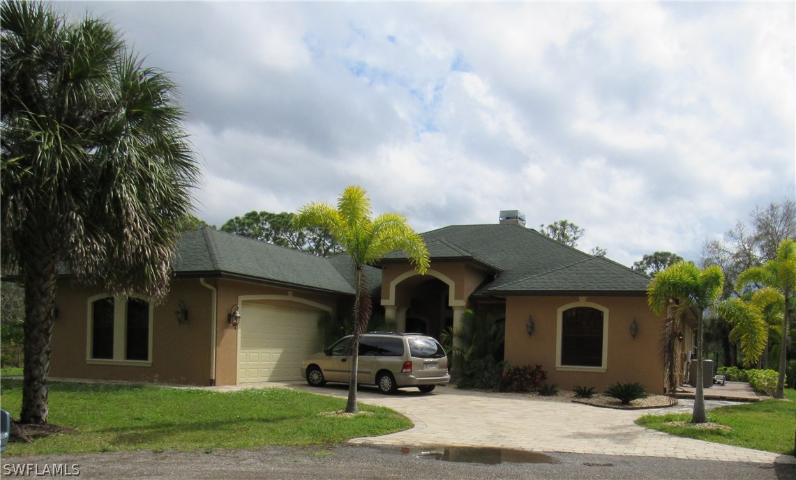 31031 Oil Well Road Punta Gorda, FL 33955 - Photo 1 of 22 a front view of a house with a garden