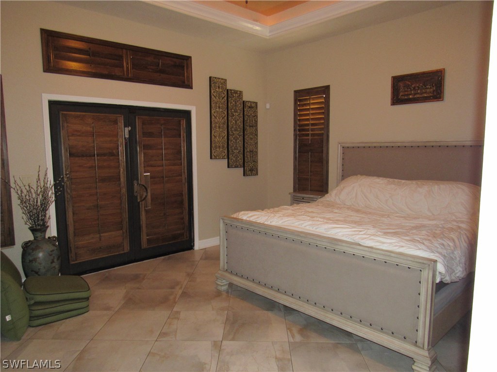 31031 Oil Well Road Punta Gorda, FL 33955 - Photo 11 of 22 a bedroom with a bed and a dresser