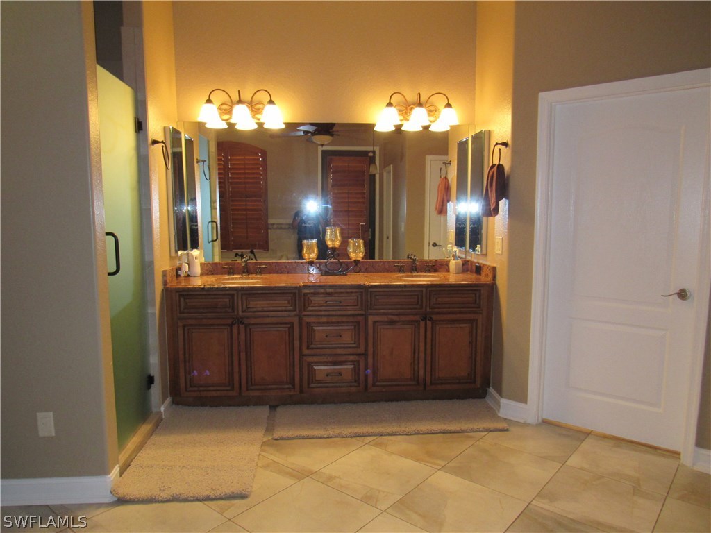 31031 Oil Well Road Punta Gorda, FL 33955 - Photo 13 of 22 a bathroom with a sink and a mirror