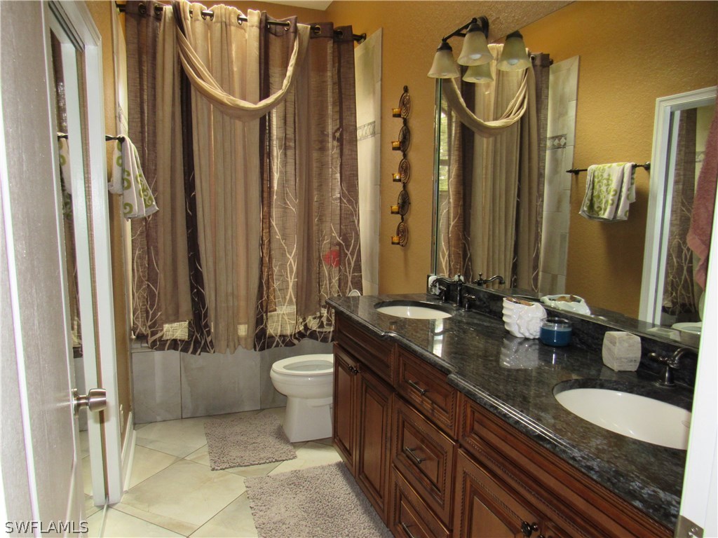 31031 Oil Well Road Punta Gorda, FL 33955 - Photo 15 of 22 a bathroom with a granite countertop sink and a mirror