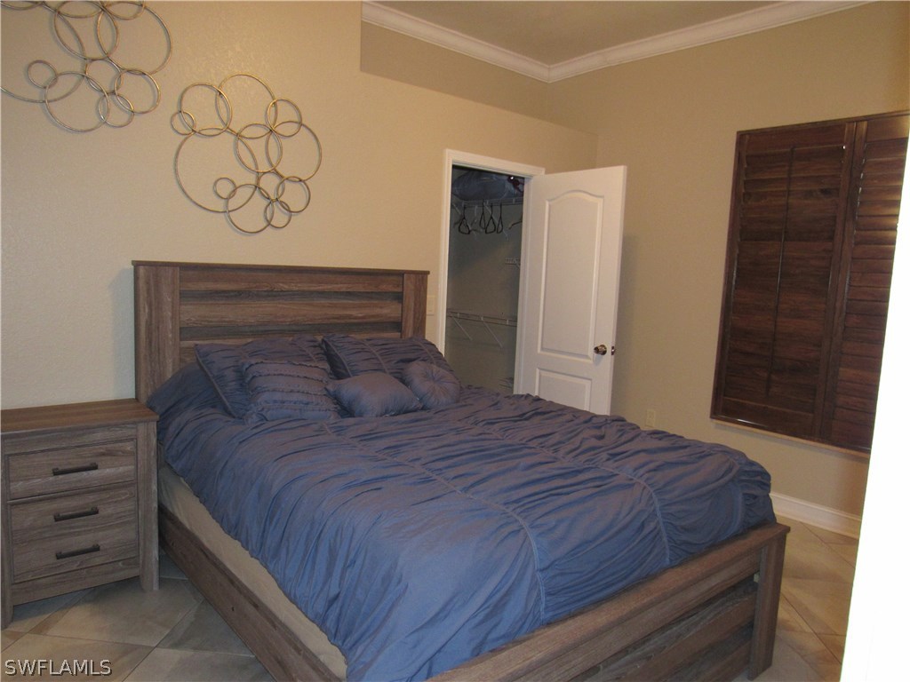31031 Oil Well Road Punta Gorda, FL 33955 - Photo 16 of 22 a bedroom with a bed and a dresser