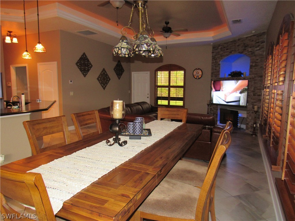31031 Oil Well Road Punta Gorda, FL 33955 - Photo 7 of 22 a dining room with wooden floor and chandelier