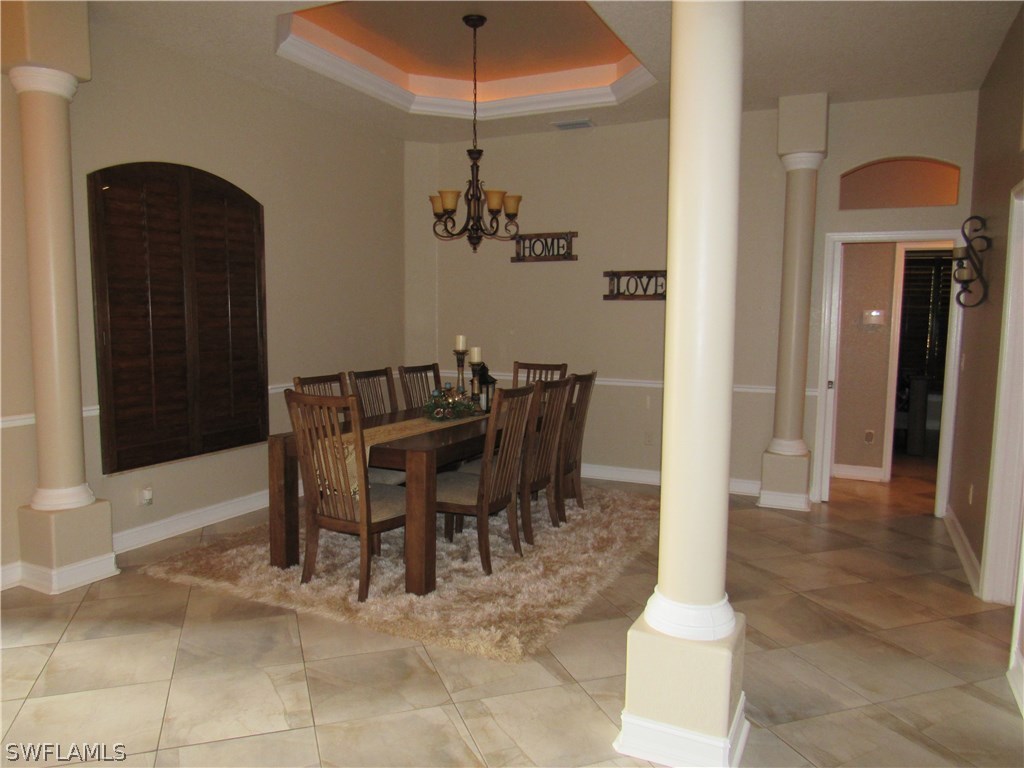 31031 Oil Well Road Punta Gorda, FL 33955 - Photo 8 of 22 a view of a dining room with furniture and chandelier