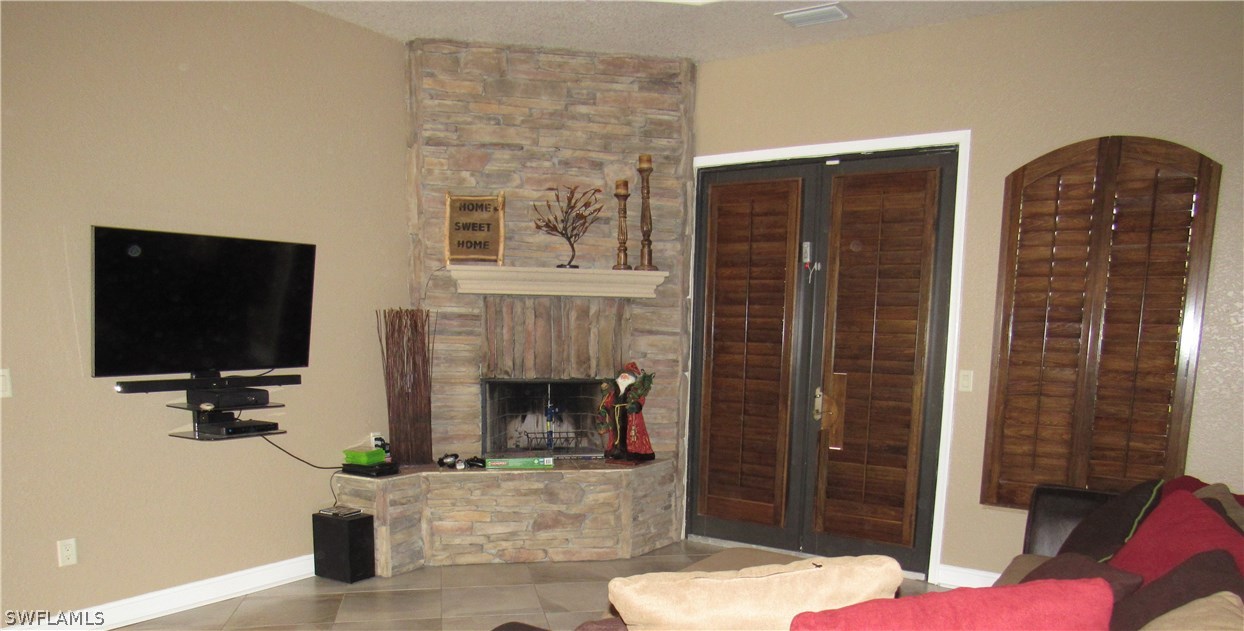 31031 Oil Well Road Punta Gorda, FL 33955 - Photo 9 of 22 a living room with furniture and a fireplace