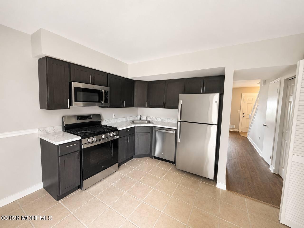 1144 Sawmill Road, Unit 121 Brick, NJ 08724 - Photo 8 of 23 a kitchen with a refrigerator stove and microwave
