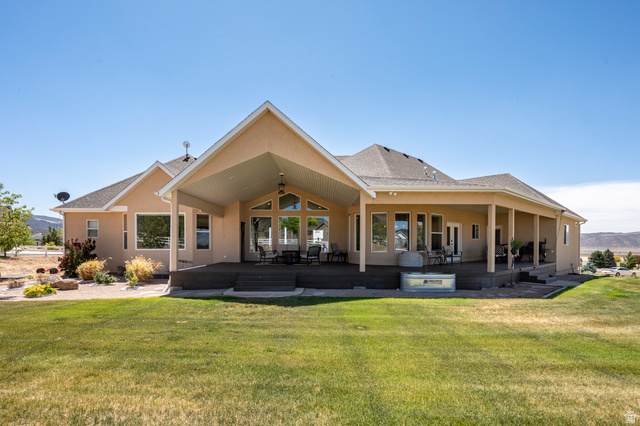 3311 West Allard Summit, UT 84772 - Photo 84 of 97 Expansive rear exterior featuring a covered patio, a full-width deck, and a large grassy area